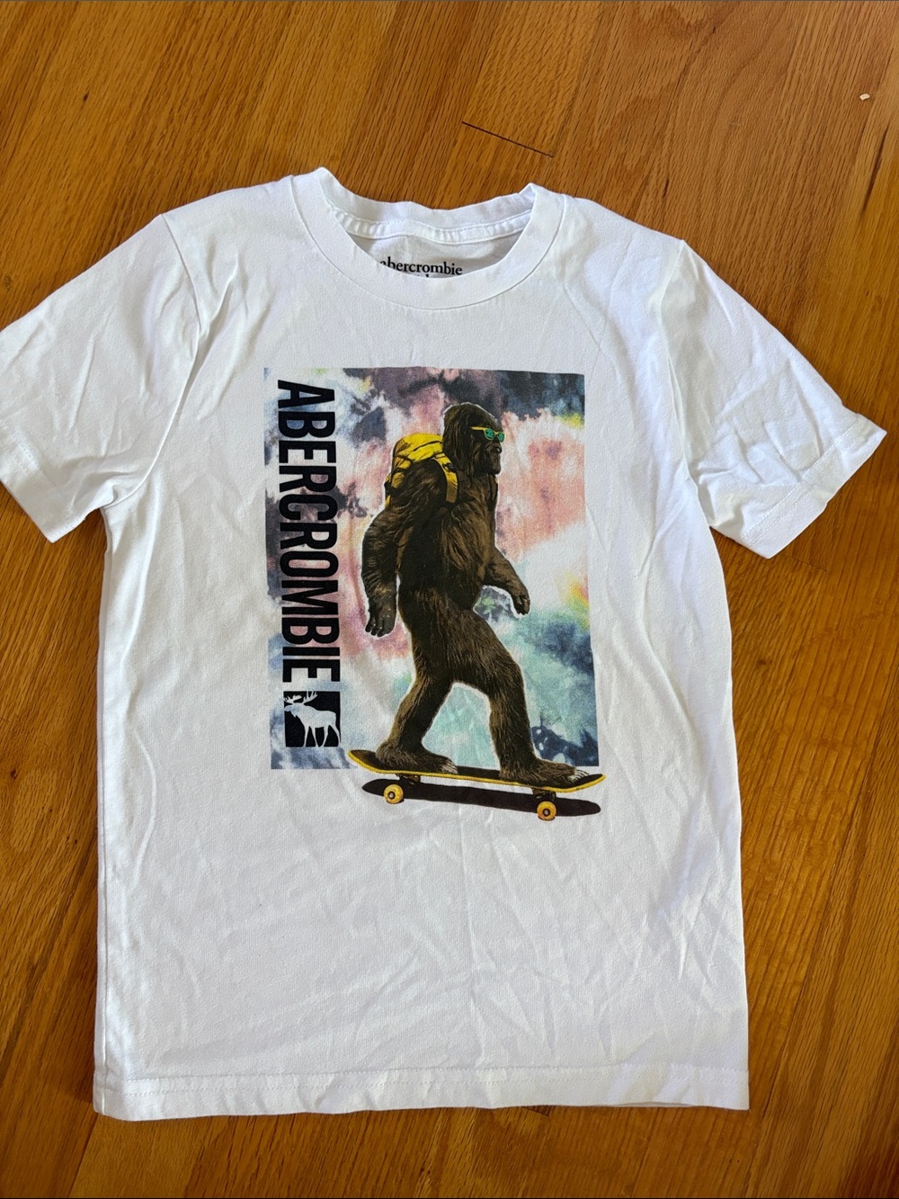 Abercrombie Kids White Tee with Colorful Skateboarding Sasquatch Graphic